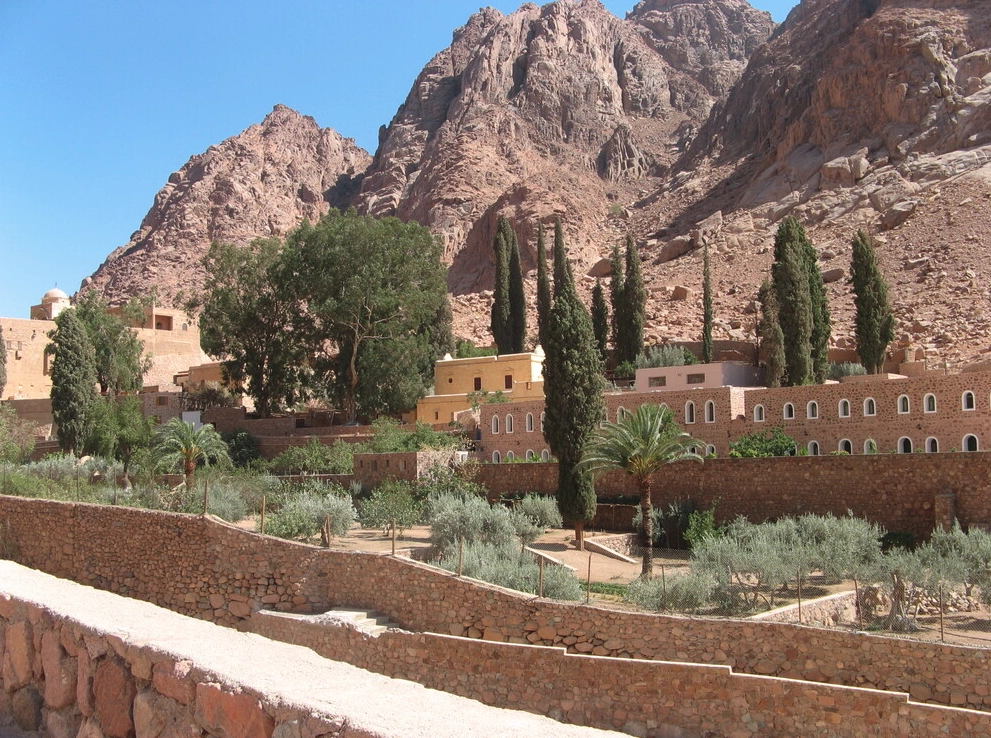 a landscape view of a mountainous area with greenery and buildings